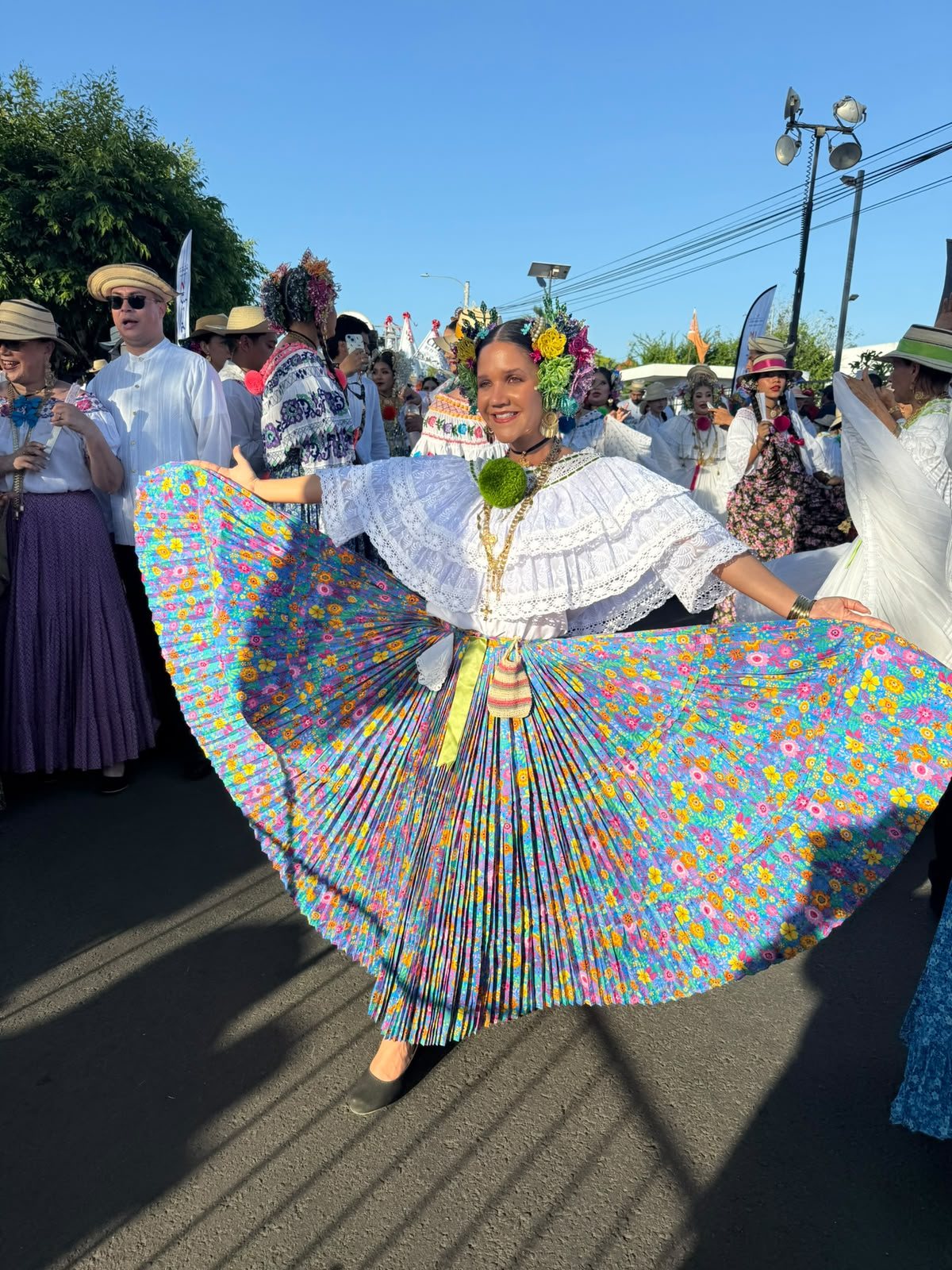 A dancer in a colorful pollera at the parade