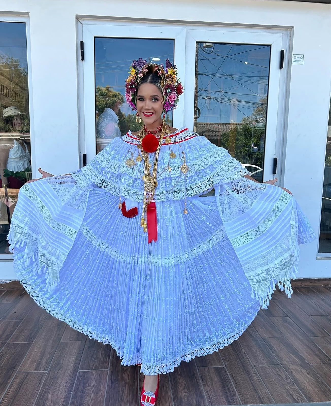 The embroidered pollera, arms outstretched
